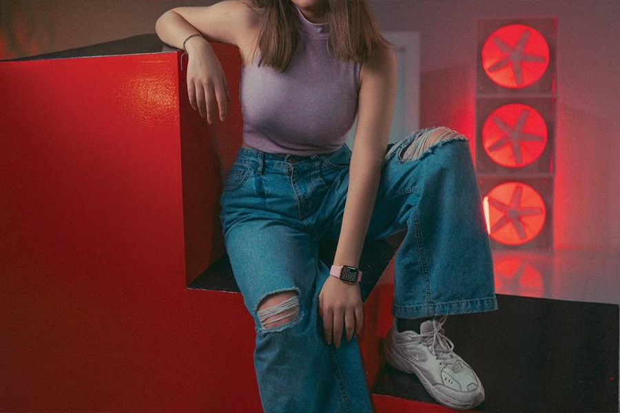 Woman rocking distressed baggy denim with sneakers