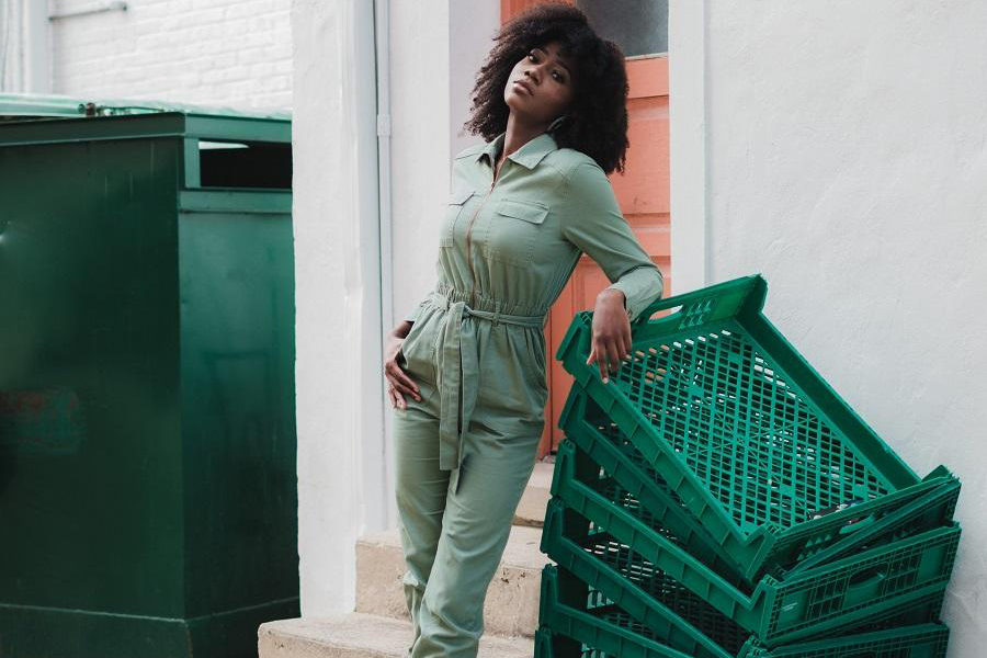 Black lady in a light green boilersuit