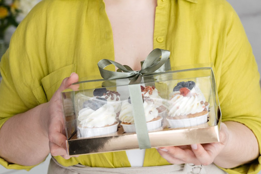 Female confectionery holding container with cupcakes