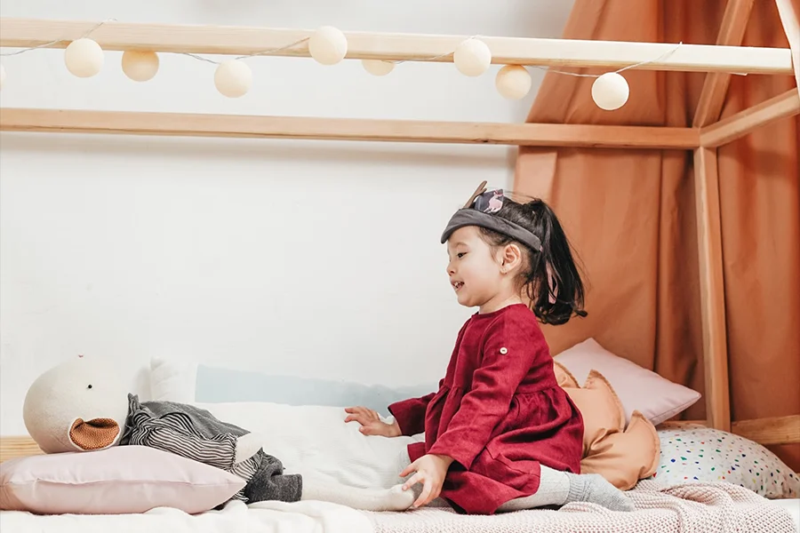 Child playing in kids princess bed