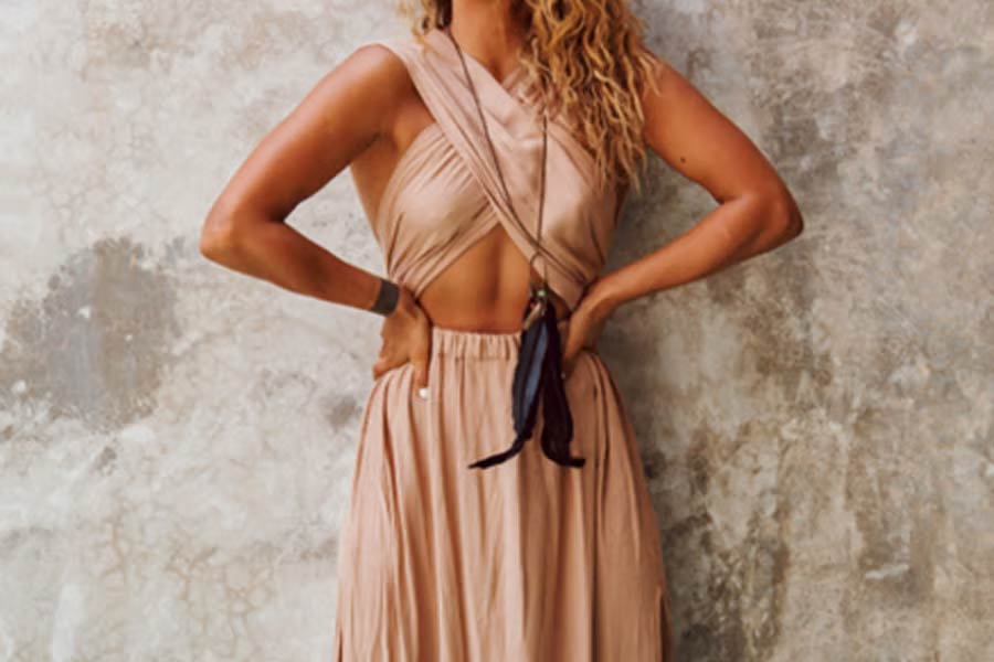 Woman in beige criss cross halter neck dress