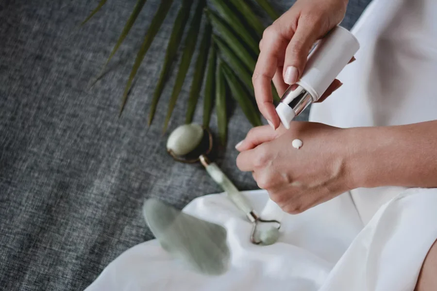 Woman putting cream on her hand for skincare routine