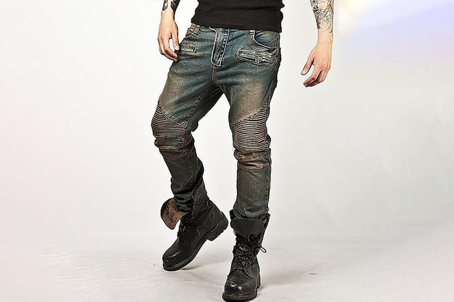 A man wearing slim trucker denim trousers