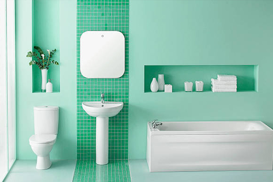 Baño verde con inodoro y lavabo a juego en blanco