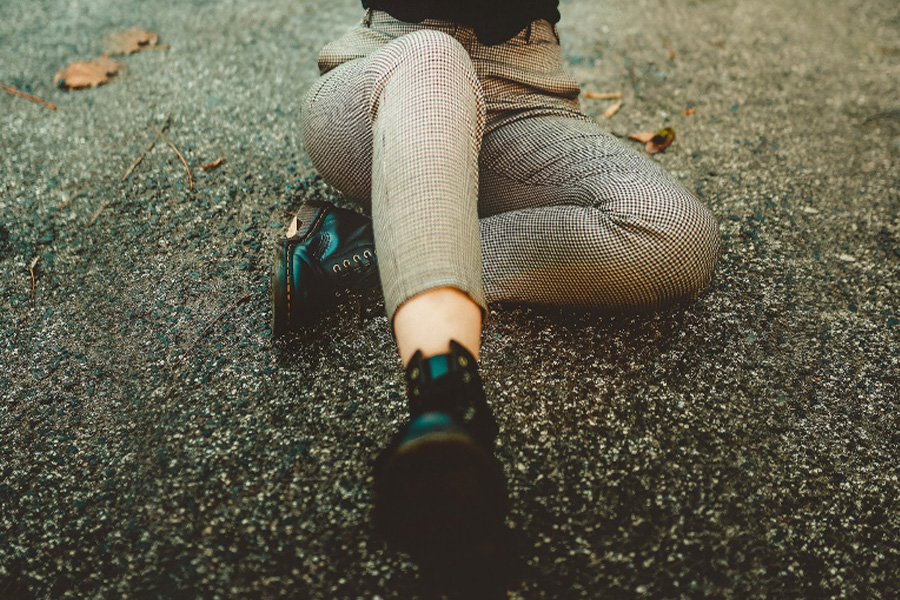 Woman wearing beige plaid slim fit trousers