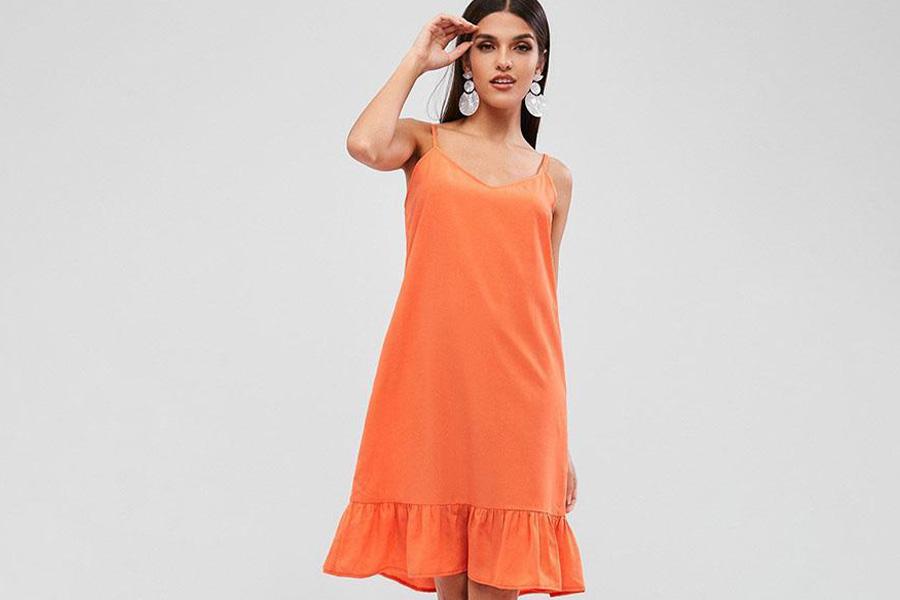 Una dama con un vestido naranja con volantes