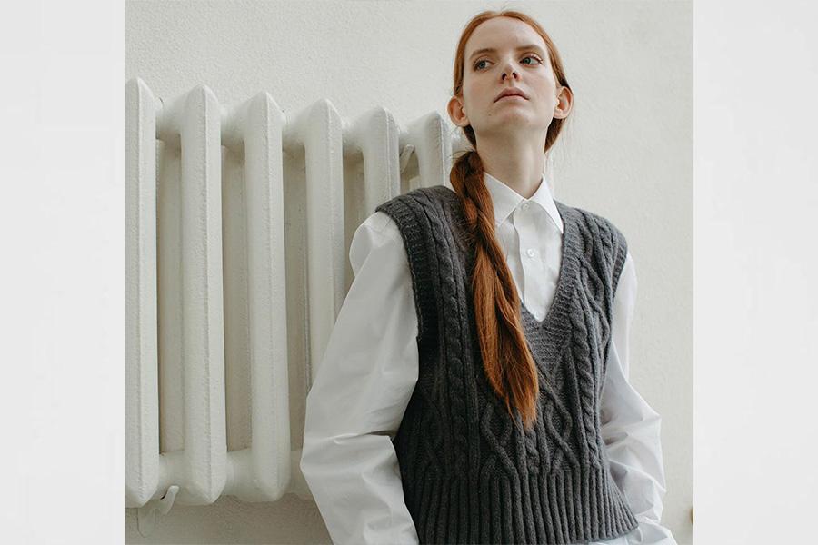 Lady rocking a gray sweater vest over a white shirt