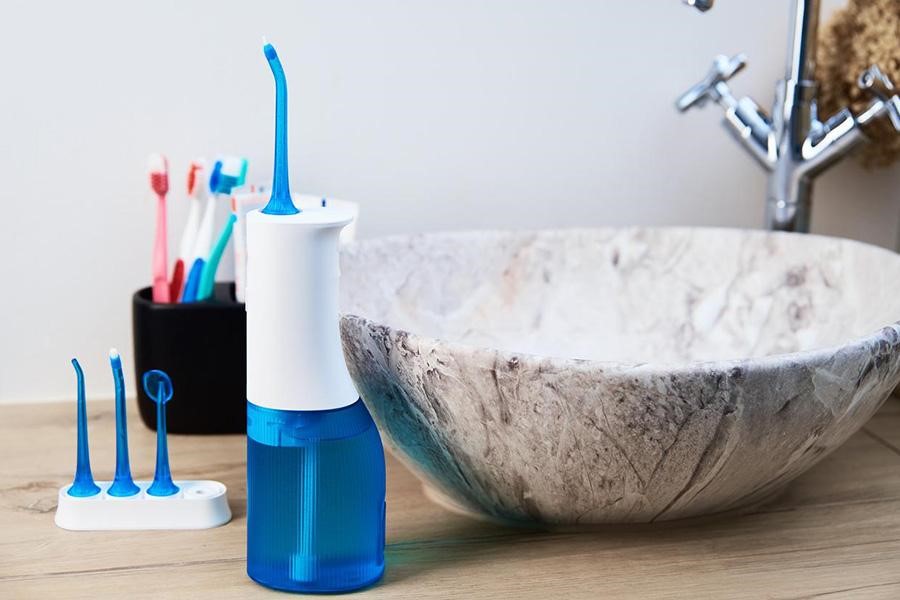 An oral irrigator kit in a bathroom