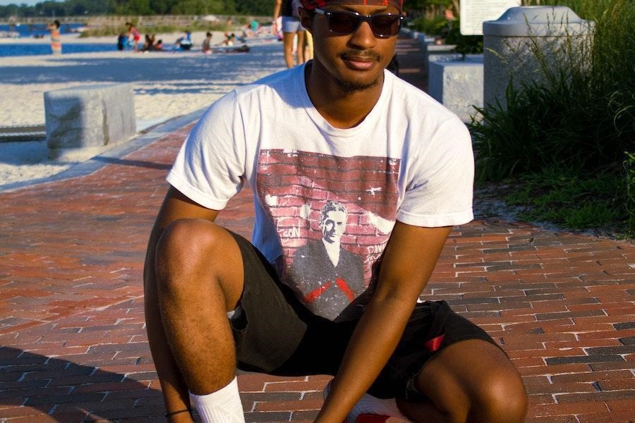 Man on knees with black boxer shorts