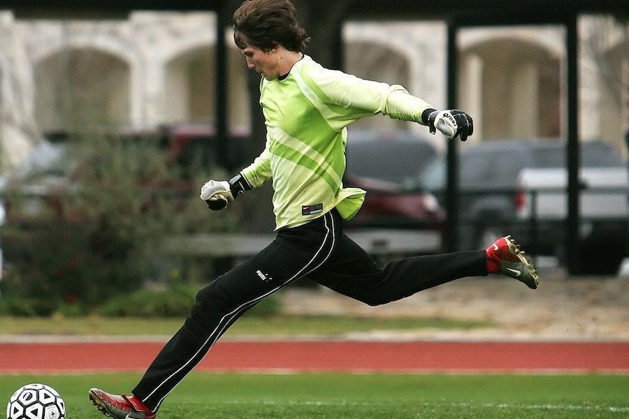 Man playing ball in black and white sports paneled pants