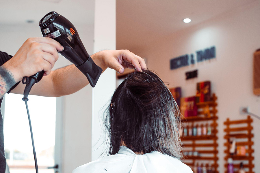 Person getting their hair blown