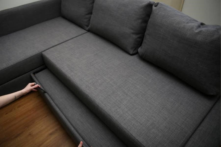 Người đang kéo phần dưới của giường sofa ra