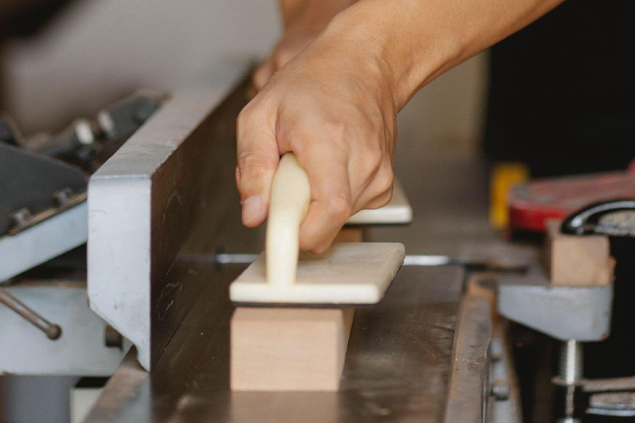 Woodworker using jointer in a workshop