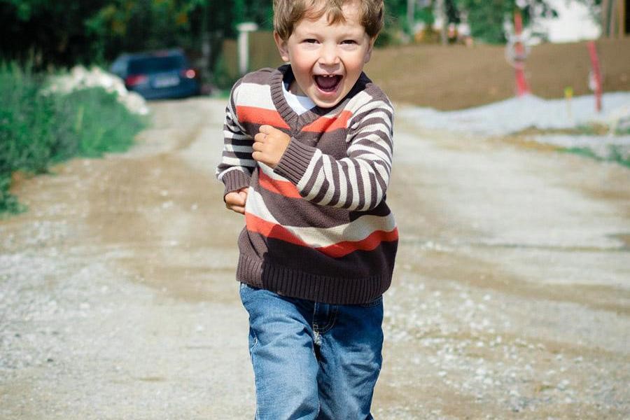 Young boy wearing a striped sweatshirt