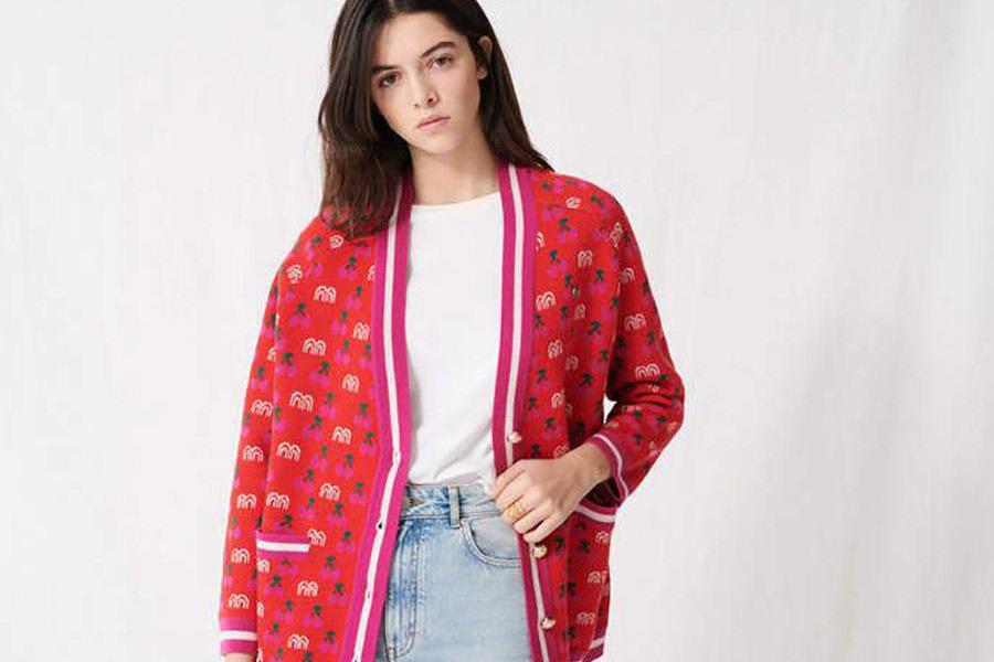 Young lady wearing a pinkish-red jacquard cardigan