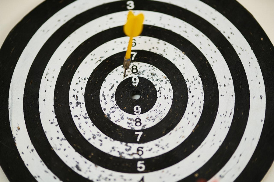 Image showcasing a black and white dartboard