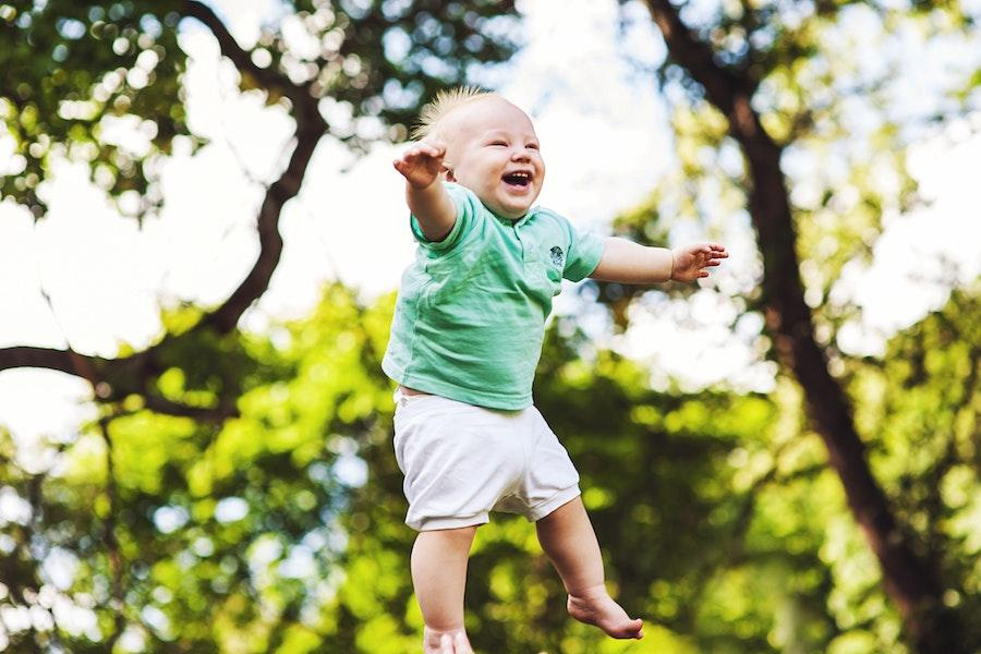 Little boy smiling with a green woven shirt