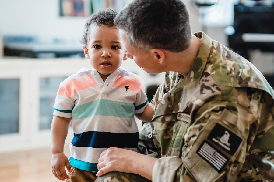 Man looking at toddler wearing a stripped printed tee