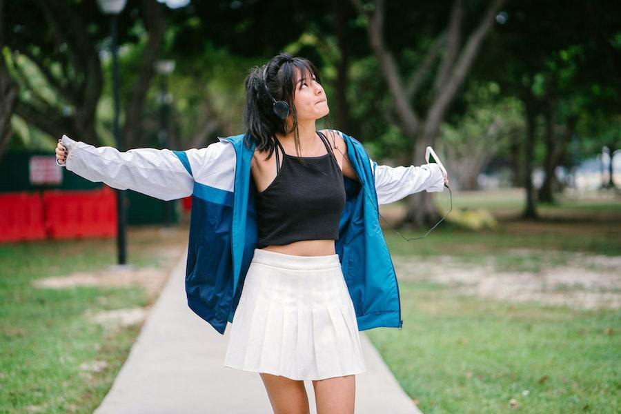 Woman looking up while rocking a white miniskirt