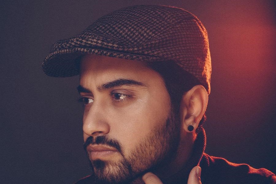 Good-looking man in a checkered flat hat