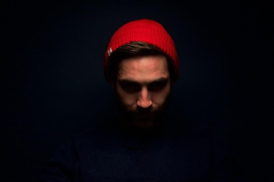 Man rocking a red beanie with a blue shirt