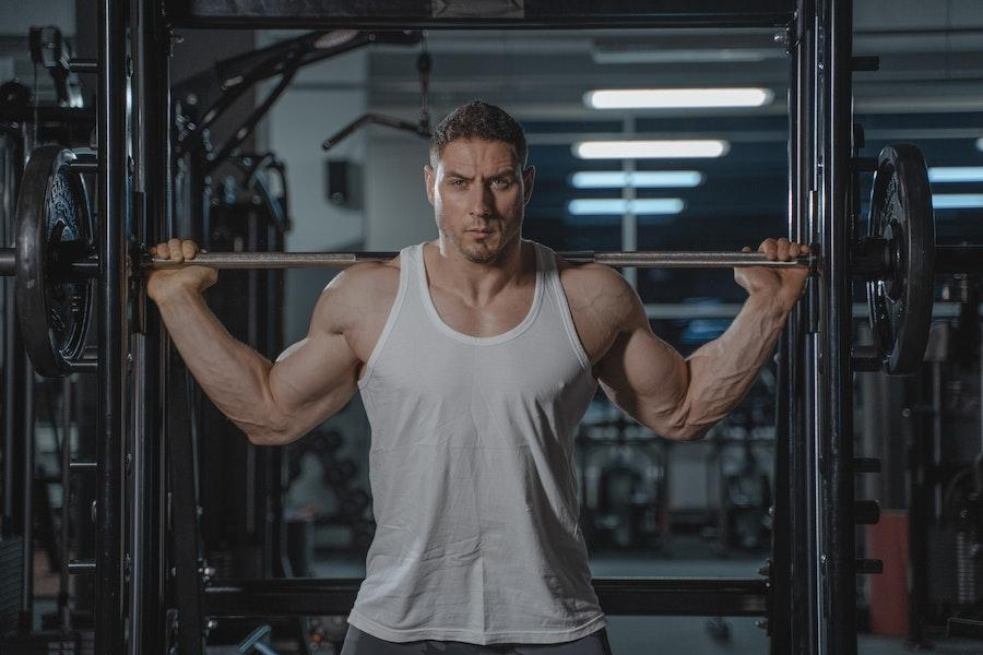 Man at the gym rocking a white tank top
