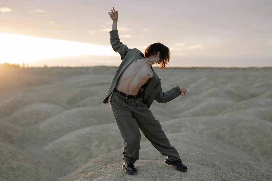 Man striking a pose while wearing a shirtless suit