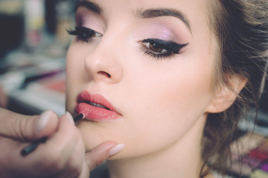 Woman with beautiful eyebrows getting her makeup done